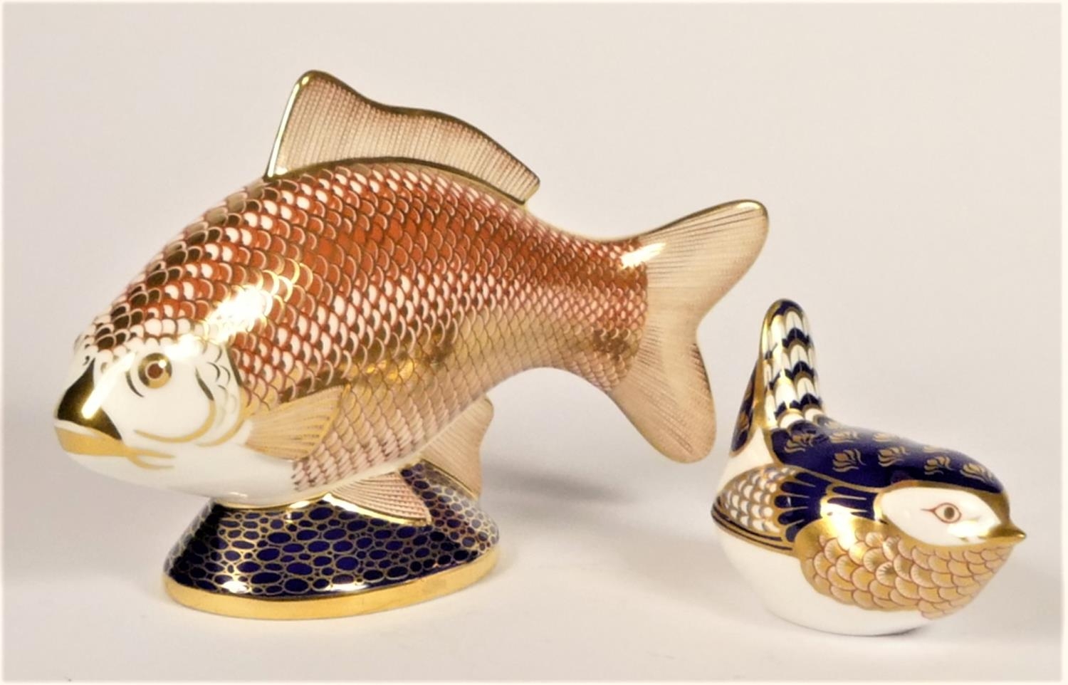 Royal Crown Derby Carp paperweight, XLIX, lacking stopper and a Wren paperweight, gold stopper (2)