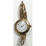 A 9ct rose gold manual wind ladies wristwatch, Birmingham 1919, the white porcelain dial with red
