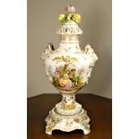 A large 19th century Dresden porcelain flower encrusted two handled urn with cover and stand,