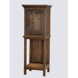 A 19th century oak cupboard on stand with carved gothic door, ornate wrought iron hinges, linen fold
