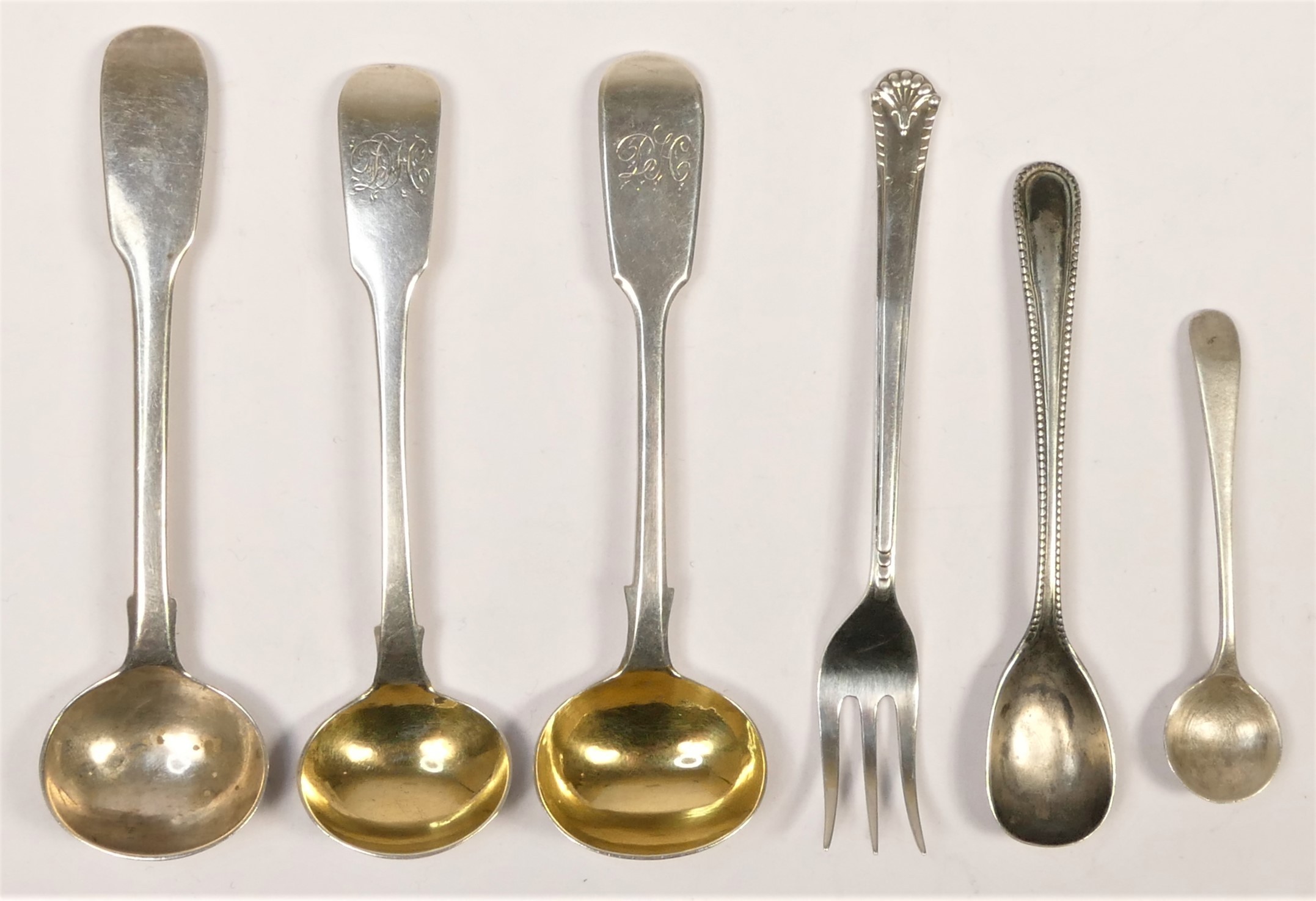 Three George III and later mustard spoons, a pickle fork and two other spoons, 51.5gm