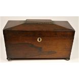 A regency rosewood tea caddy, the sarcophagus hinged lid opening to reveal a replacement glass