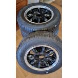 A set of four alloy Minilite type wheels, ex MG Midget (or Morris 1000), shod with unused