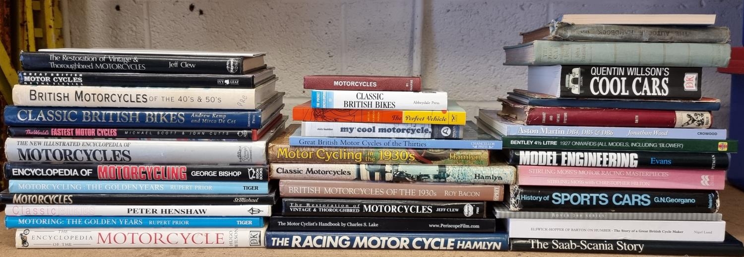 A collection of motorcycle and motorcar related books, including The Sports Car by John Stanford