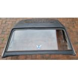 An MGB fibreglass hard top roof with pop up sunroof and vinyl covering