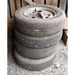 A set of four MGB Rostyles wheels with assorted tyres