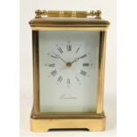 A French manual wind carriage clock, brass cased with bevelled glass panels. 13cm tall.