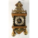 A Dutch Zaanse Zaadam atlas wall clock, complete with brass pear shaped weights and pendulum. 48cm