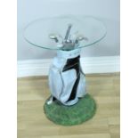 A novelty resin golfing side table in the form of a bag of clubs with, circular tuffin glass top,