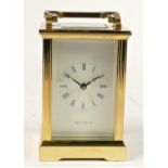 A Mappin & Webb manual wind carriage clock, brass case with bevelled edge glass panels, white