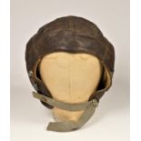 A WWII era leather flying helmet, lacking ear covers