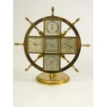 Angelus weather station clock, in the form of a brass ship's wheel on round stepped base, with five