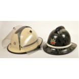 Two South Yorkshire Police helmets, together with two fire helmets, Humberside Fire Brigade, with