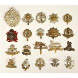 A collection of 22 military cap badges, to include Royal Armoured Corps, Cheshire and South Staffs