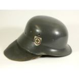 A replica German ''Stahlhelm', decorated with painted swastika, with leather neck protector