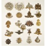 A collection of 22 military cap badges, to include Australian and North Staffs