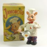 A Jamoncito cocinero cooking chef automaton, in the form of pig, plastic with fabric clothing,