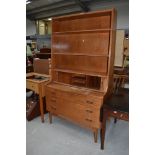 A mid 20th Century Danish teak burea bookcase having tambour shutter and compartmental interior,