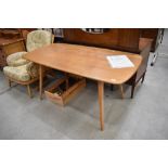 An Ercol light stain dining table, approx. 150 x 75cm