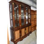 A modern Oriental hardwood bookcase having brass clasps and handles and table and chairs