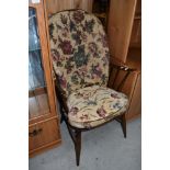 A traditional dark stained Ercol Windsor chair, having spindle frame