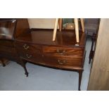 An early 20th Century mahogany dressing chest of two over one long draw, having bow front and