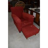 A Howard style chair of long narrow proportions and a similar footstool, later upholstery in red
