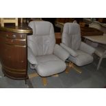 A pair of leather recliner armchairs, not Stressless, seats a bir perished