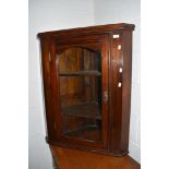 A traditional stained frame corner wall display cupboard
