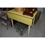 A vintage formica topped drop leaf kitchen table