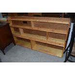 A pine and chipboard back low bookcase, width approx. 170cm