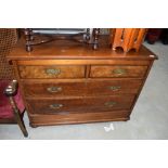 A 19th Century mahogany and walnut chest of two over two drawers, raised on semi bun feets and metal