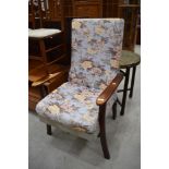 A traditional stained frame upholstered armchair