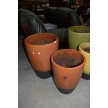 Two glazed clay planters and pots, largest being a height of 60cm