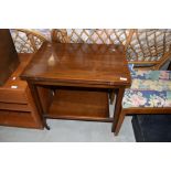 A vintage sapele tea trolley having fold over card table top, closed dimensions approx. 65 x 45cm