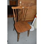 A traditional stained frame spindle and vase back kitchen chair