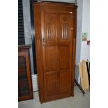 An early 20th Century traditional oak hall robe having linen fold and panelled doors, width