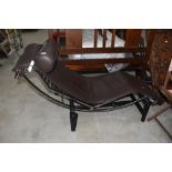 A modernist style chaise longue, having chrome frame, Le Corbusier design, brown leather upholstery