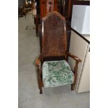 An early 20th Century cane back armchair