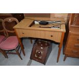 A vintage Singer sewing machine table with integral machine