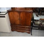 A reproduction mahogany TV cabinet, width approx. 80cm