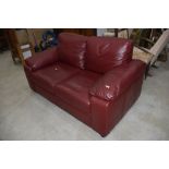 A modern burgundy leatherette two seater settee, width approx. 160cm
