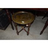 A small Indian brass tray table on stained barley twist frame