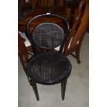A traditional bentwood cane work chair, in black