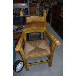 A heavy rush seated carver chair