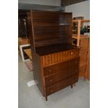 A vintage mahogany dresser of stylised form having display shelf back over three drawers, the top