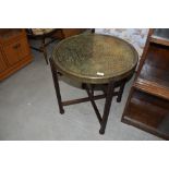 A traditional Indian brass circular table on wood frame, diameter approx. 60cm