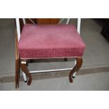 A traditional dressing table stool having dralon upholstered stuffed seat on cabriole legs