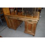 A large rustic pine twin pedestal desk, having ornate brass handles, width approx. 140cm depth 88cm