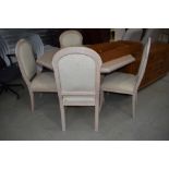 A modern octagonal table and 4 chairs in glossed limed oak and peach effect